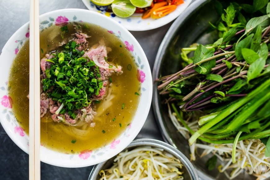 A steaming bowl of Pho, a quintessential Vietnamese noodle soup