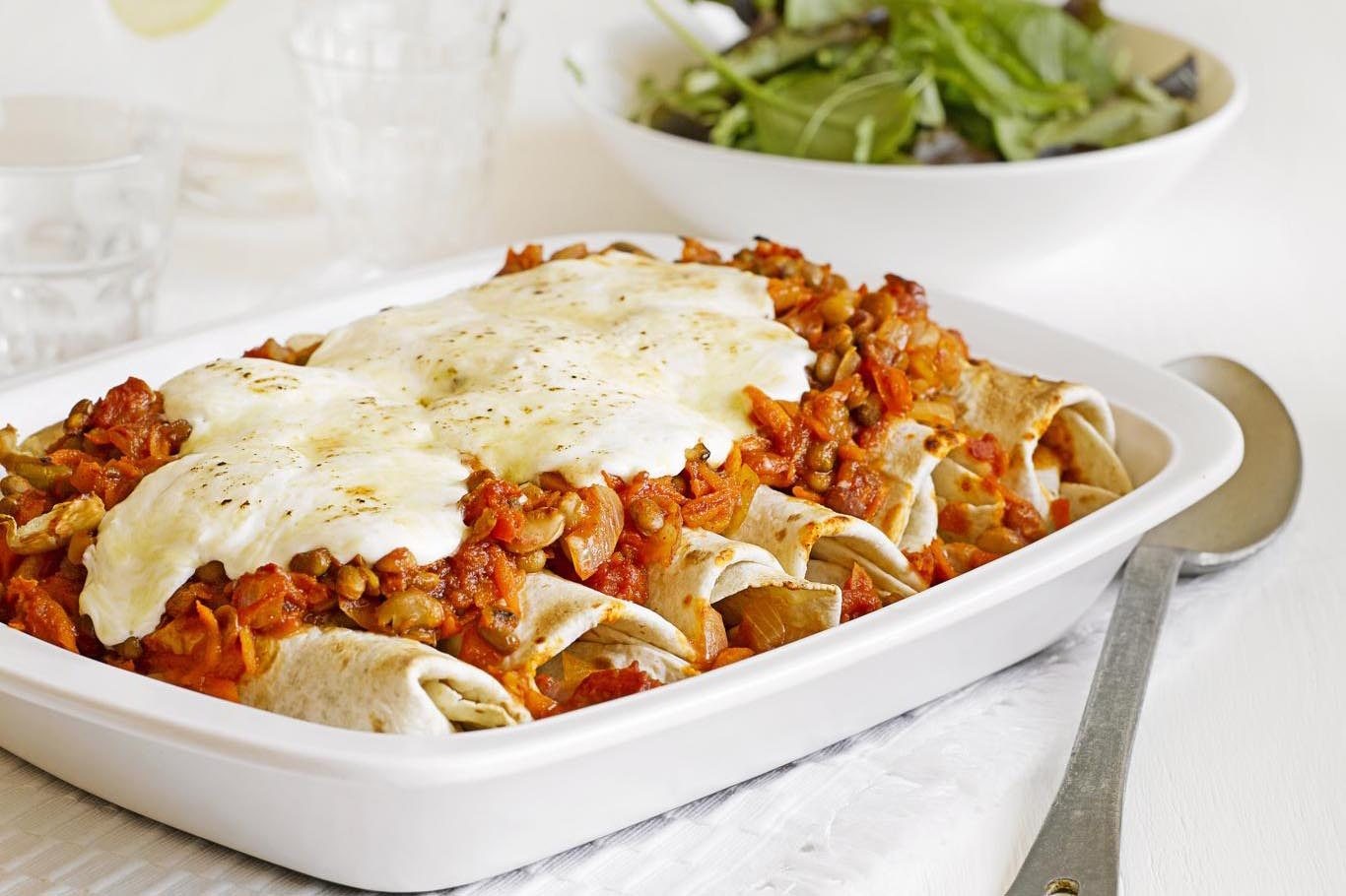 vegetarian enchiladas in a white oven dish