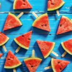 Freshly sliced watermelon pieces, showcasing the vibrant red flesh and black seeds.