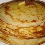 A close-up of blini, showcasing its texture and various toppings.