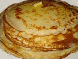A close-up of blini, showcasing its texture and various toppings.