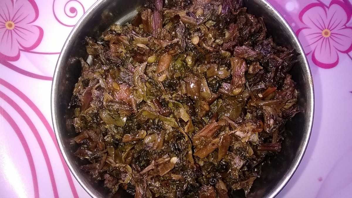 A bowl of Gundruk Achar featuring fermented or pickled green and leafy vegetables