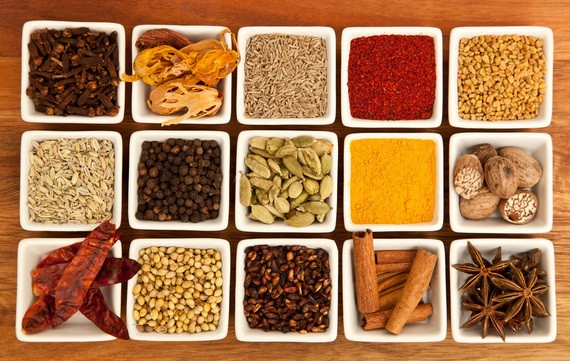 Assortment of vibrant Indian spices, including turmeric, cumin, coriander, and chili powder, commonly used in authentic Indian cooking