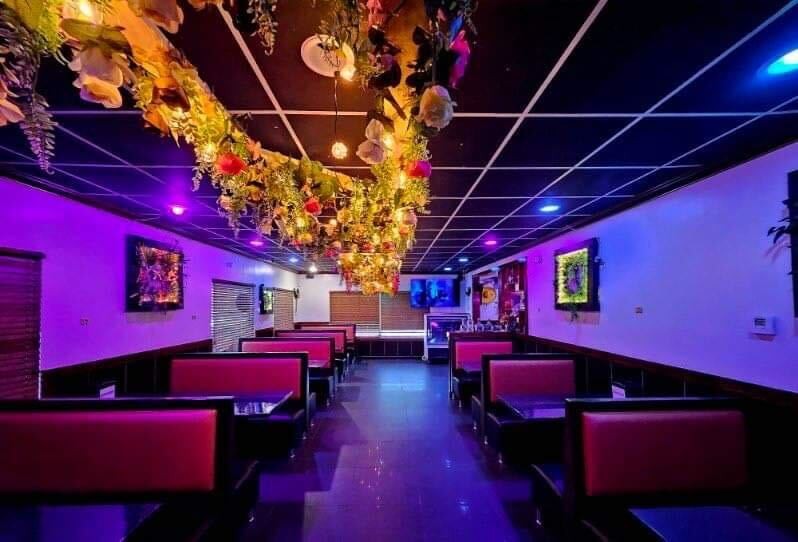 A vibrant outdoor dining scene in Lawrence KS, showcasing a variety of cuisines and a lively atmosphere