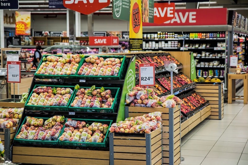 Woman Selecting Fresh Produce at a Grocery Store