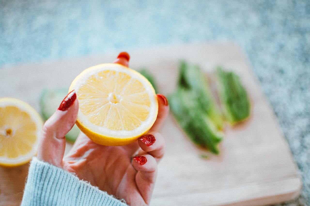 A person holding an orange