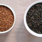 Bowls of brown and black rice, showcasing healthier options for weight loss.