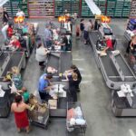 WinCo employee bagging groceries, showcasing the company's customer-focused approach and employee ownership