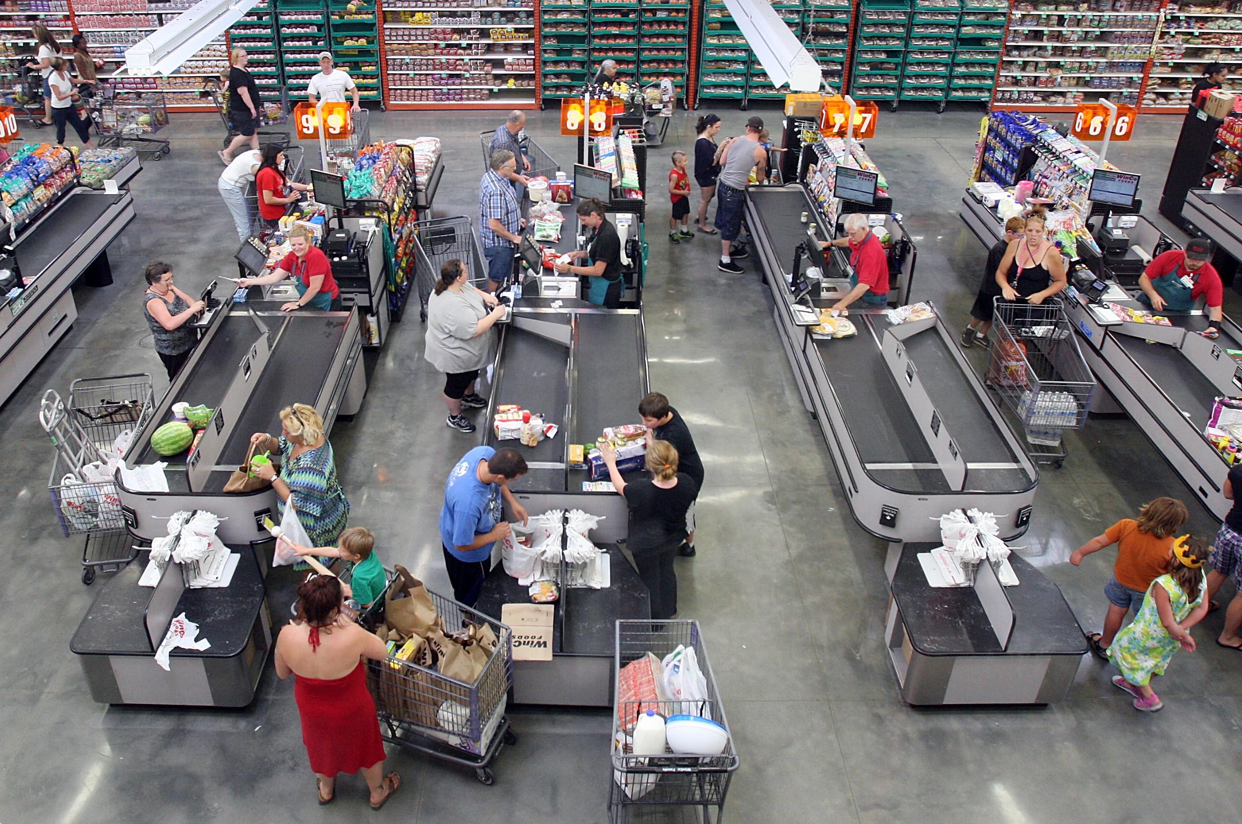 WinCo employee bagging groceries, showcasing the company's customer-focused approach and employee ownership