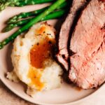 Grilled steak served with creamy mashed potatoes and a side of asparagus.