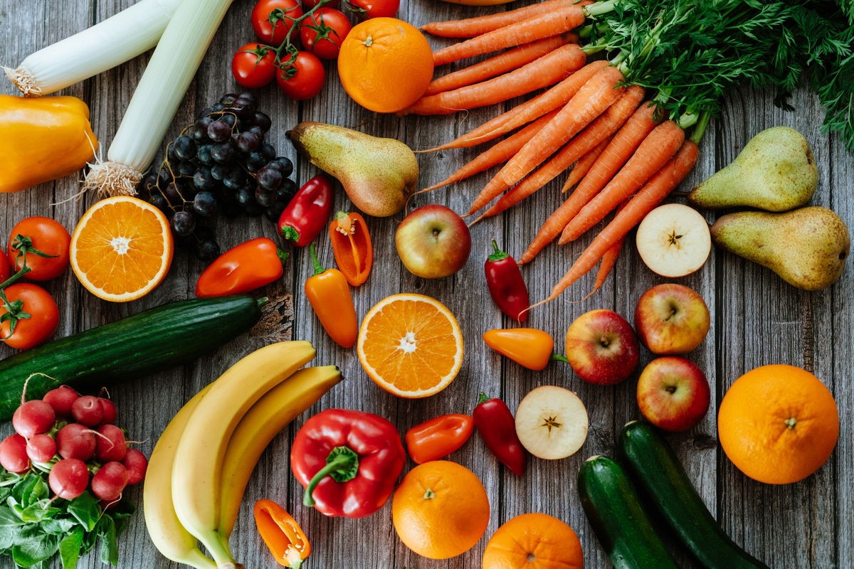 A variety of colorful diuretic foods including watermelon, celery, and green tea