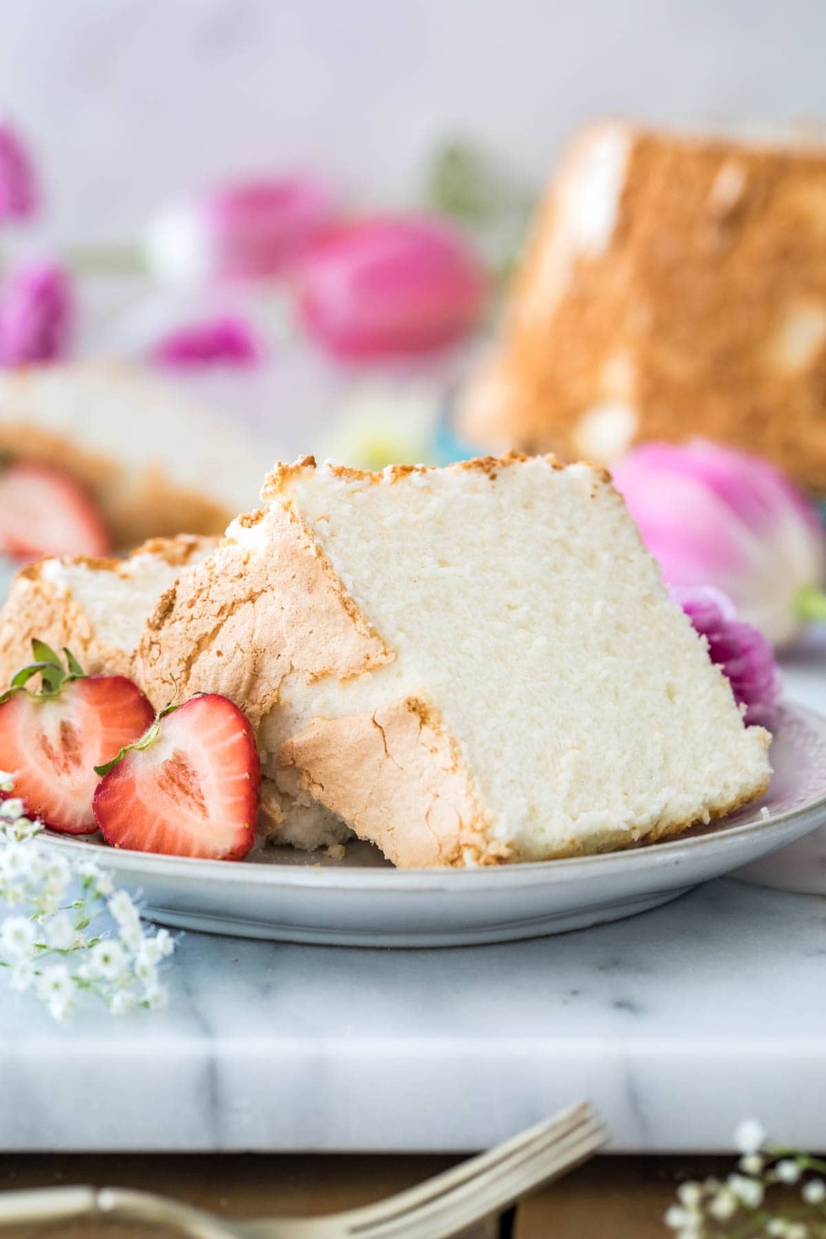 Angel Food Cake slices on a plate with strawberries