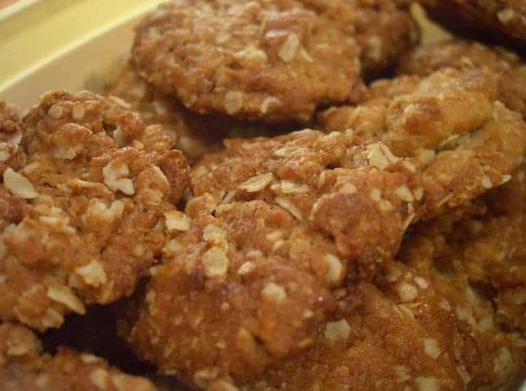 Traditional Australian Anzac Biscuits, showcasing their golden brown color and textured surface, made from rolled oats, coconut, and golden syrup.