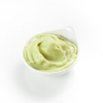 Bowl of Avocado and pea baby food puree.