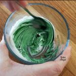 icing with green colour being added to it