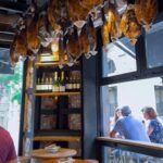 Vacuum-sealed Serrano ham in a Barcelona market, showcasing the accessibility of this Barcelona food staple, with alt text Spanish Serrano ham vacuum packed at a Barcelona market.
