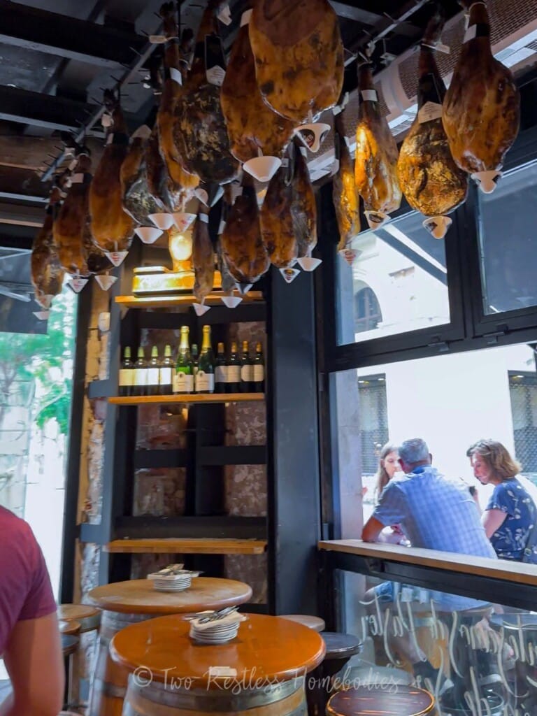 Vacuum-sealed Serrano ham in a Barcelona market, showcasing the accessibility of this Barcelona food staple, with alt text Spanish Serrano ham vacuum packed at a Barcelona market.