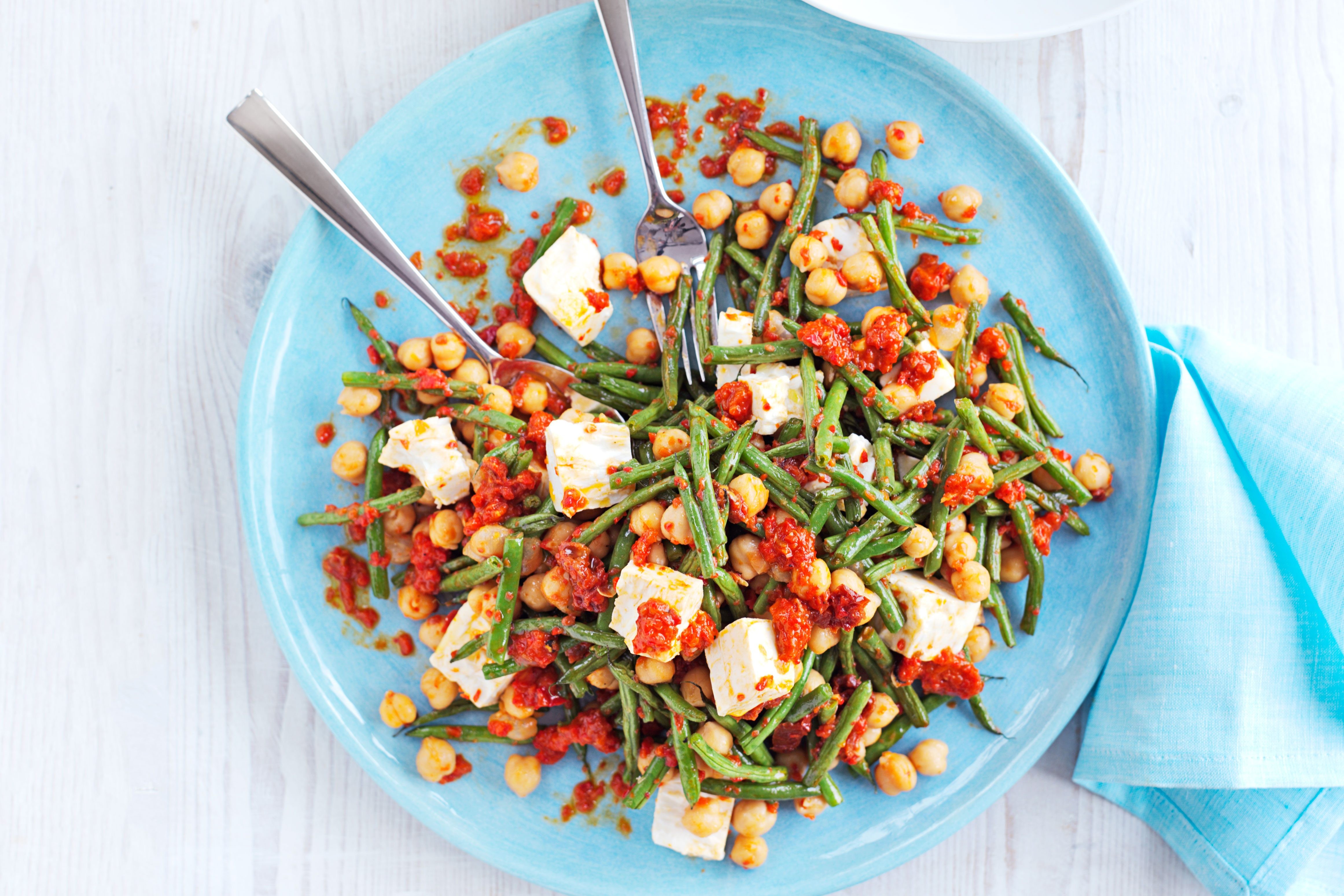 Beans, chickpeas, and feta on a plate.