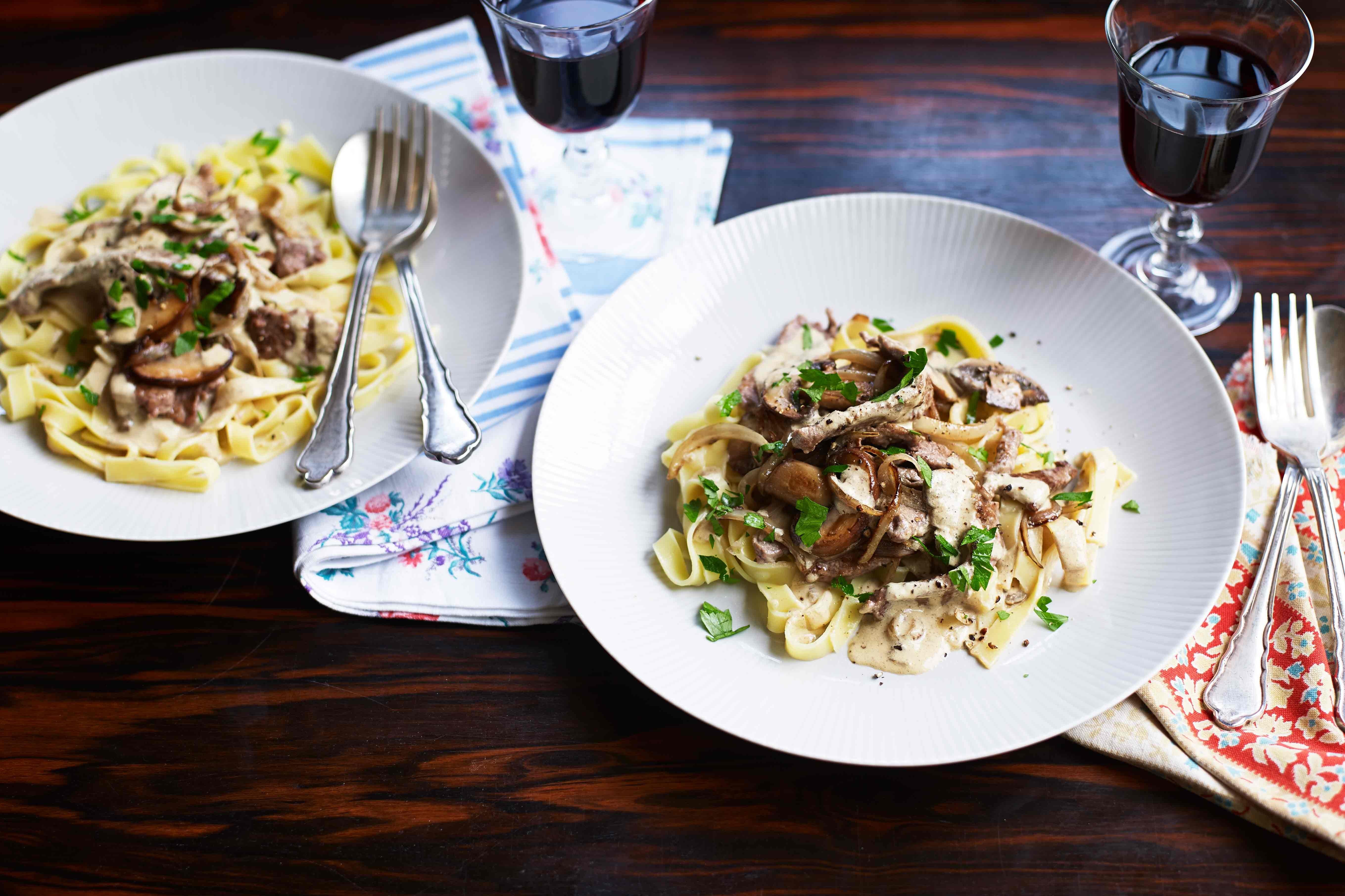 A plate of beef stroganoff over pappardelle pasta