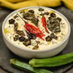 A cooling bowl of raita with fresh herbs and spices, enhancing any Indian meal.