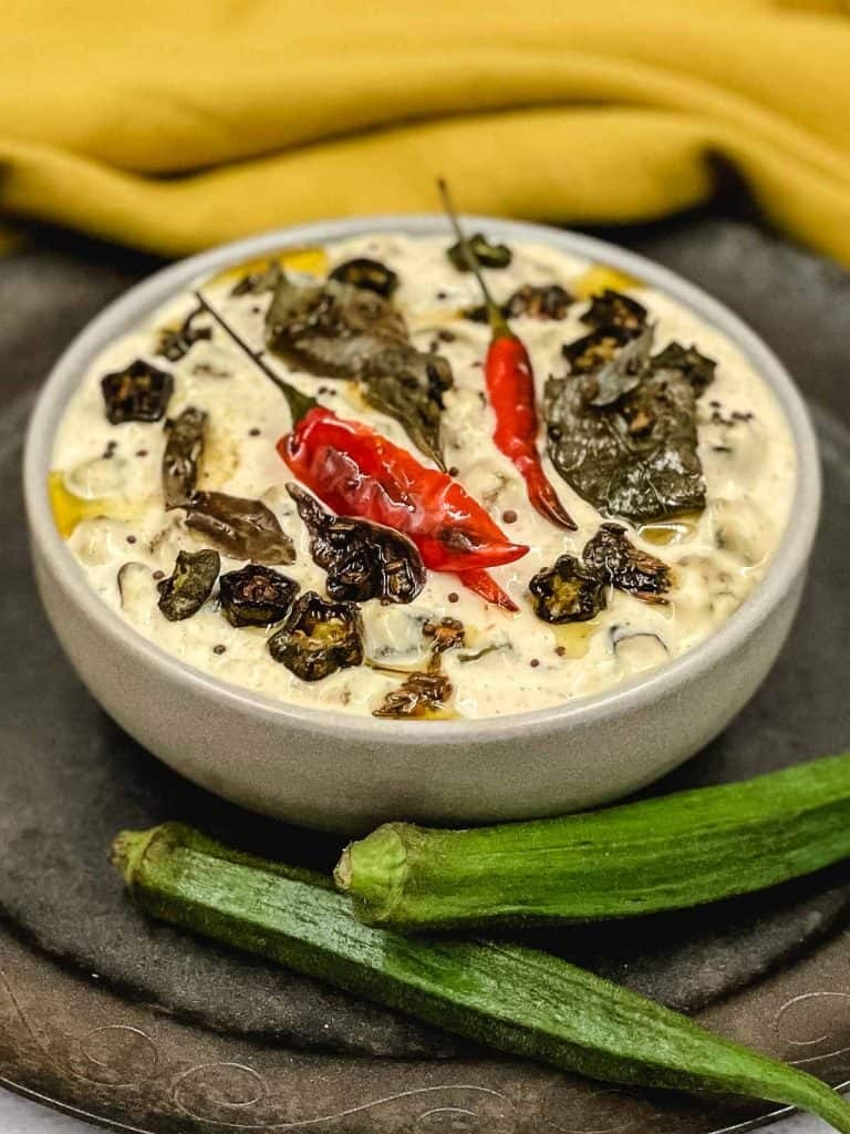 A cooling bowl of raita with fresh herbs and spices, enhancing any Indian meal.