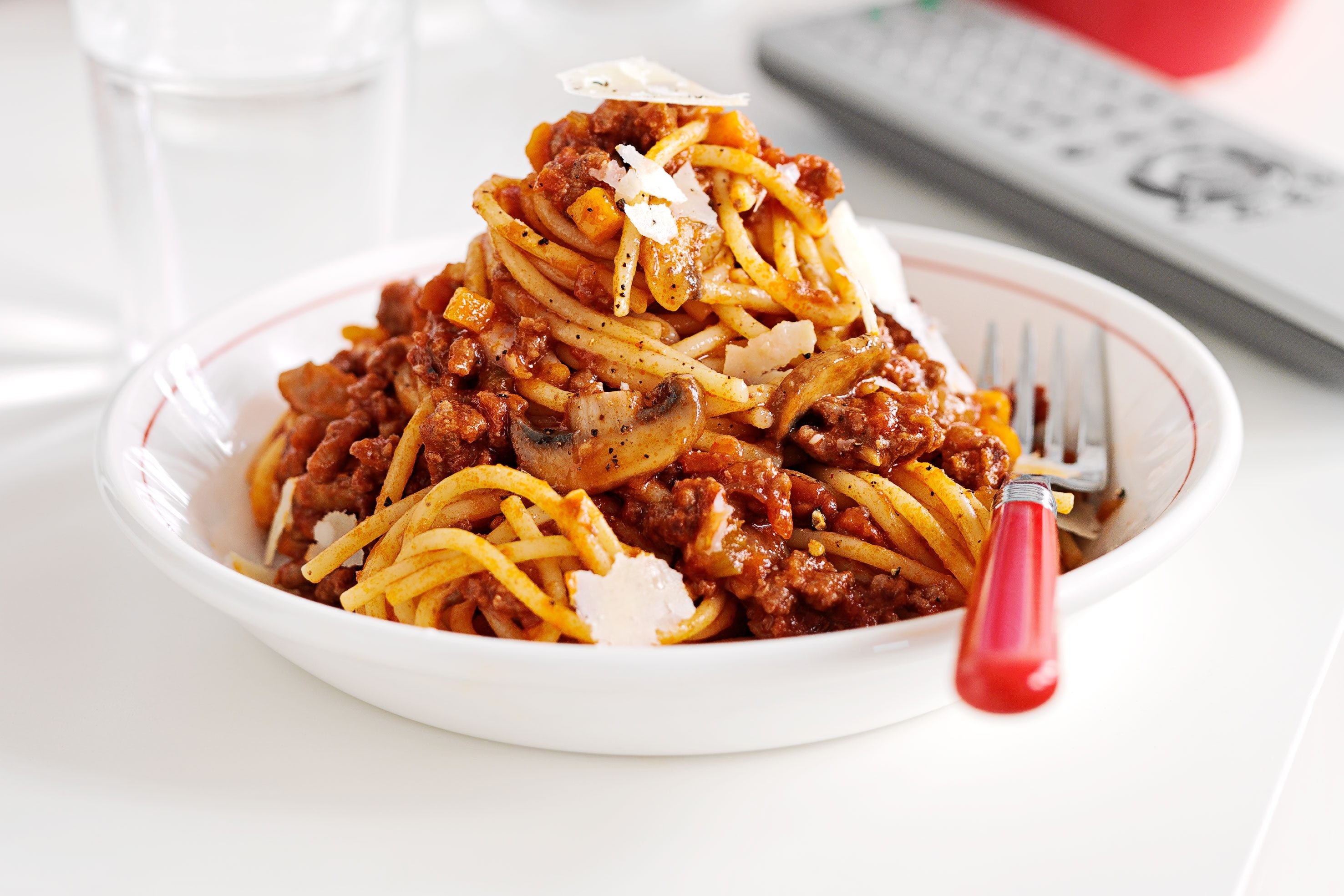 Spaghetti bolognese piled on a plate.