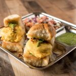 Bombay Street Food Vada Pav, Mumbai's iconic burger, featuring a spiced potato patty in a soft bun with flavorful chutneys