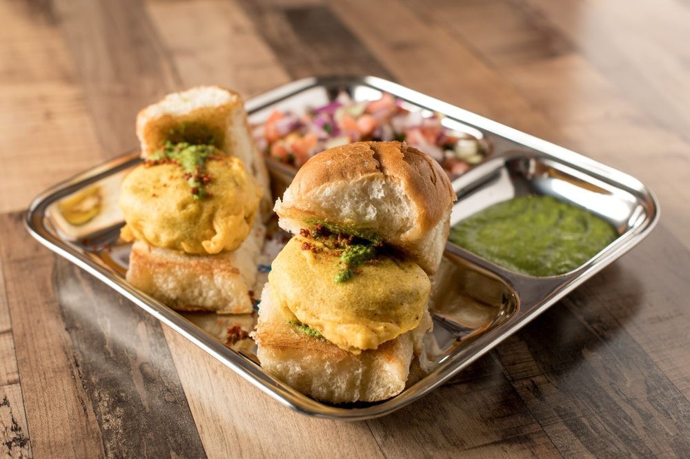 Bombay Street Food Vada Pav, Mumbai's iconic burger, featuring a spiced potato patty in a soft bun with flavorful chutneys