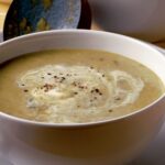 Bowl of B'ssara soup garnished with olive oil and cumin, a traditional Moroccan breakfast.