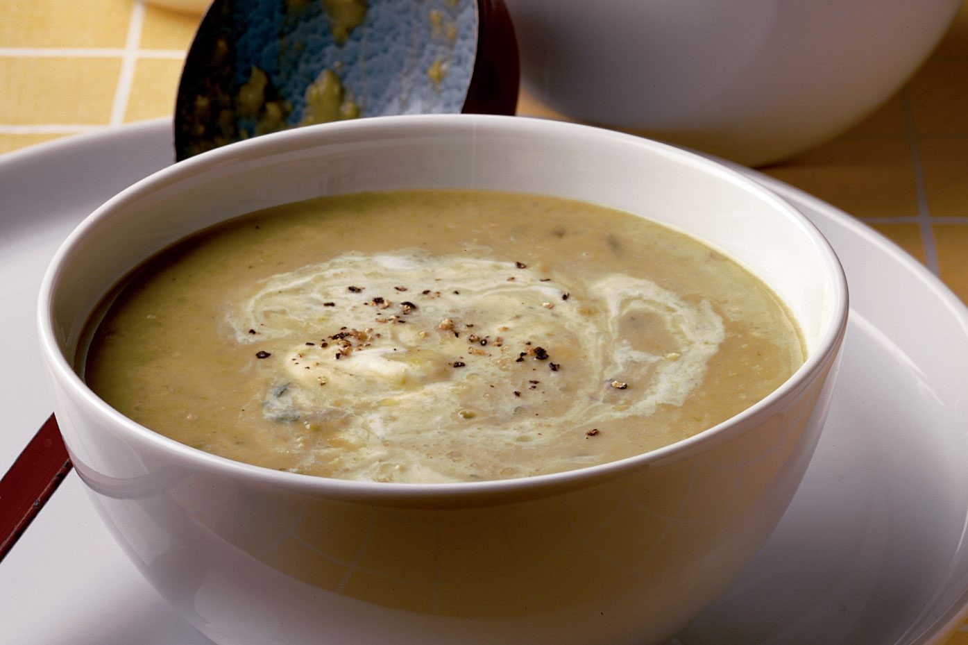 Bowl of B'ssara soup garnished with olive oil and cumin, a traditional Moroccan breakfast.