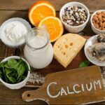 Image showing food rich in calcium: milk, oranges, cheese, salmon, nuts, seeds and spinach