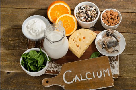 Image showing food rich in calcium: milk, oranges, cheese, salmon, nuts, seeds and spinach