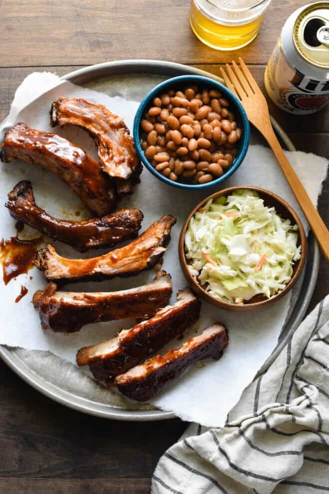 A delicious plate of ribs with various side dishes, showcasing a balanced meal.
