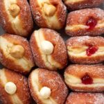 Jelly doughnuts filled with strawberry jam and dusted with powdered sugar