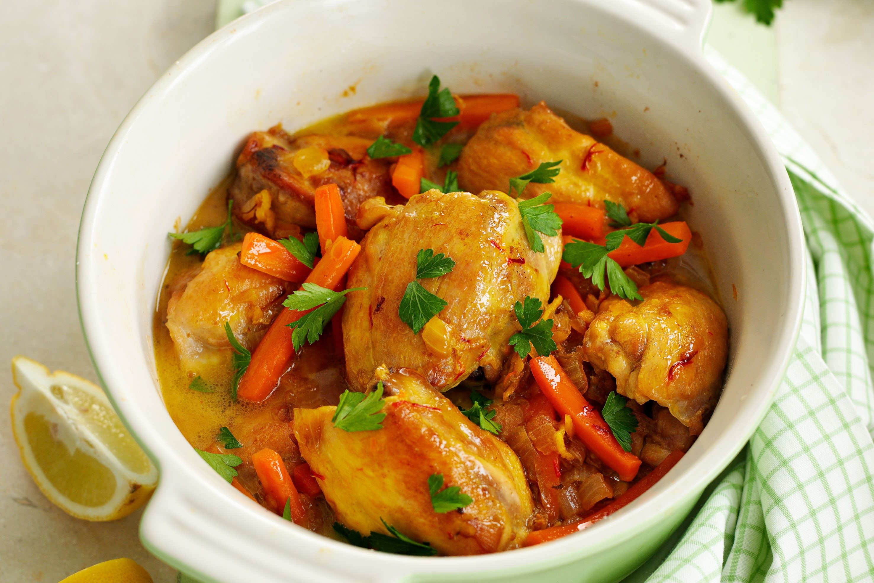 A steaming pot of chicken tagine, showcasing the traditional Moroccan cooking vessel and the rich flavors within.