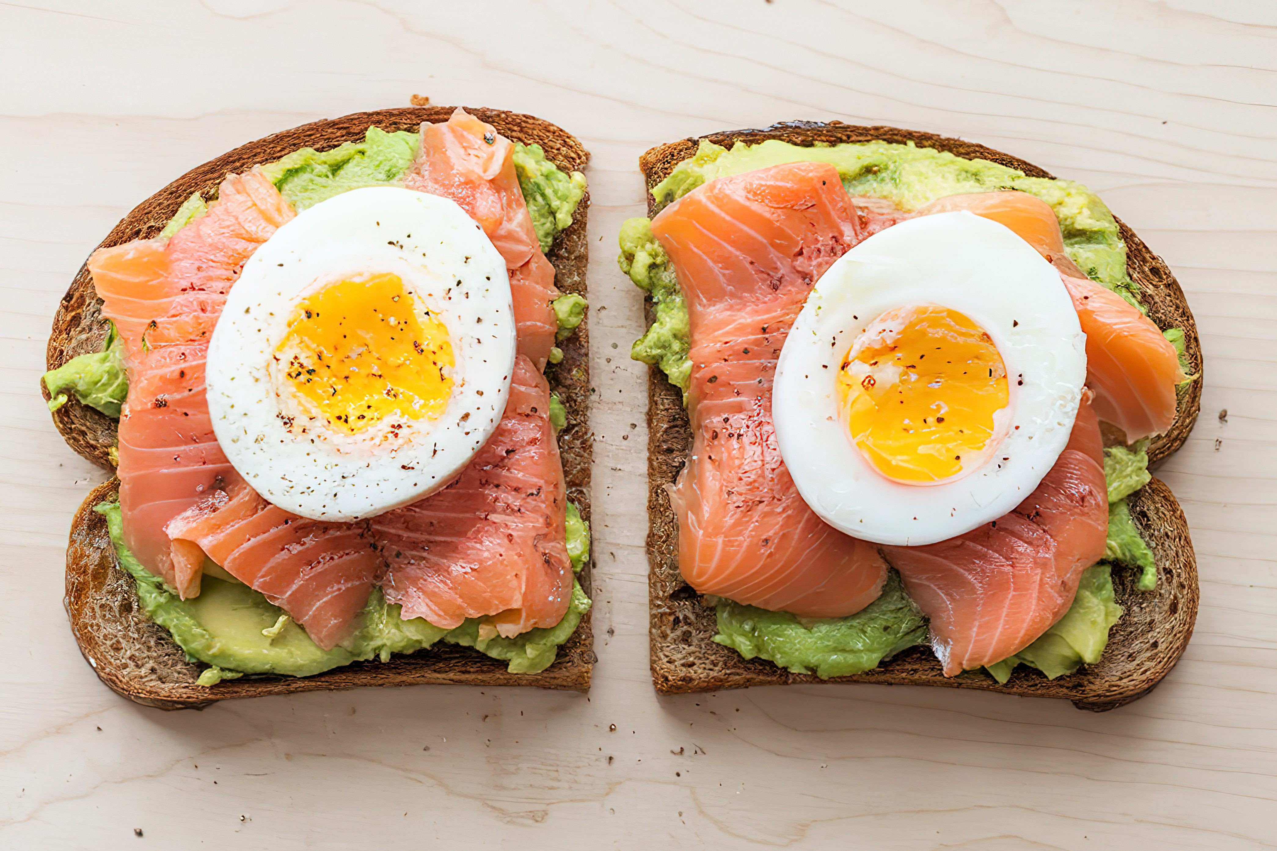 Avocado toast with eggs and salmon provides healthy fats, protein, and sustained energy to slow alcohol absorption