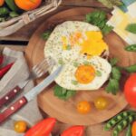 Brown eggs in a carton, representing a common vegetarian food