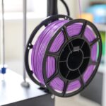 Purple filament spool on 3D printer