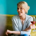 pouring red wine into glass to enhance digestion