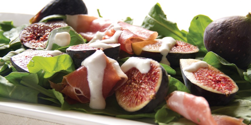 Speck and cheese board featuring Gruyère and Parmesan, paired with figs and apples