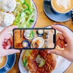 Food critic taking notes while tasting a dish