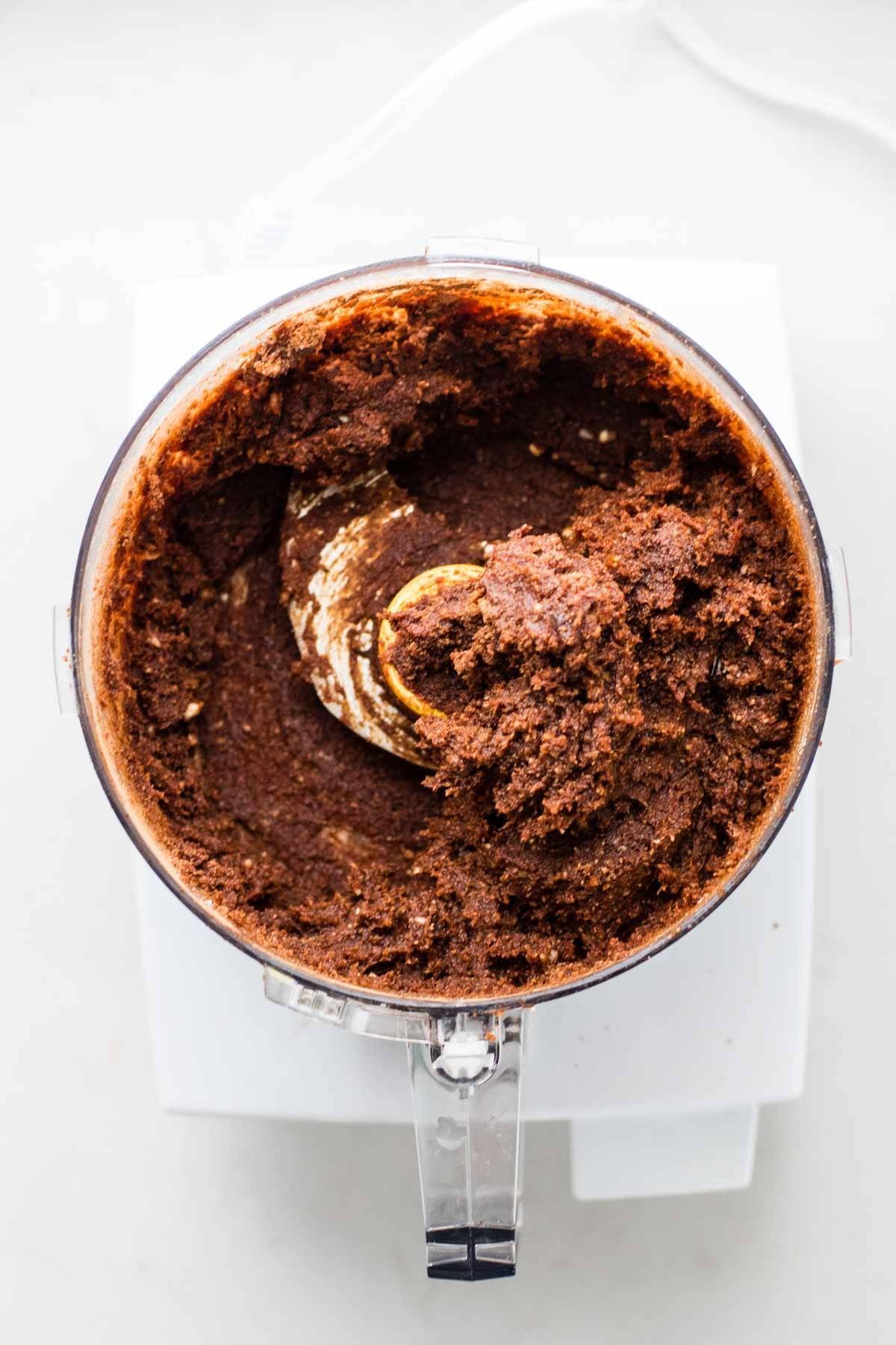 Chocolate truffles being made in a food processor, demonstrating the appliance's ability to create healthy snacks.