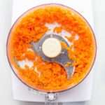 Vegetables being chopped in a food processor, demonstrating the appliance's efficiency in dicing and chopping tasks.