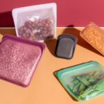 Several clear, heavy-duty freezer slider bags filled with colorful fruits and vegetables, showcasing their airtight seal and convenient slider closure for effective food preservation.