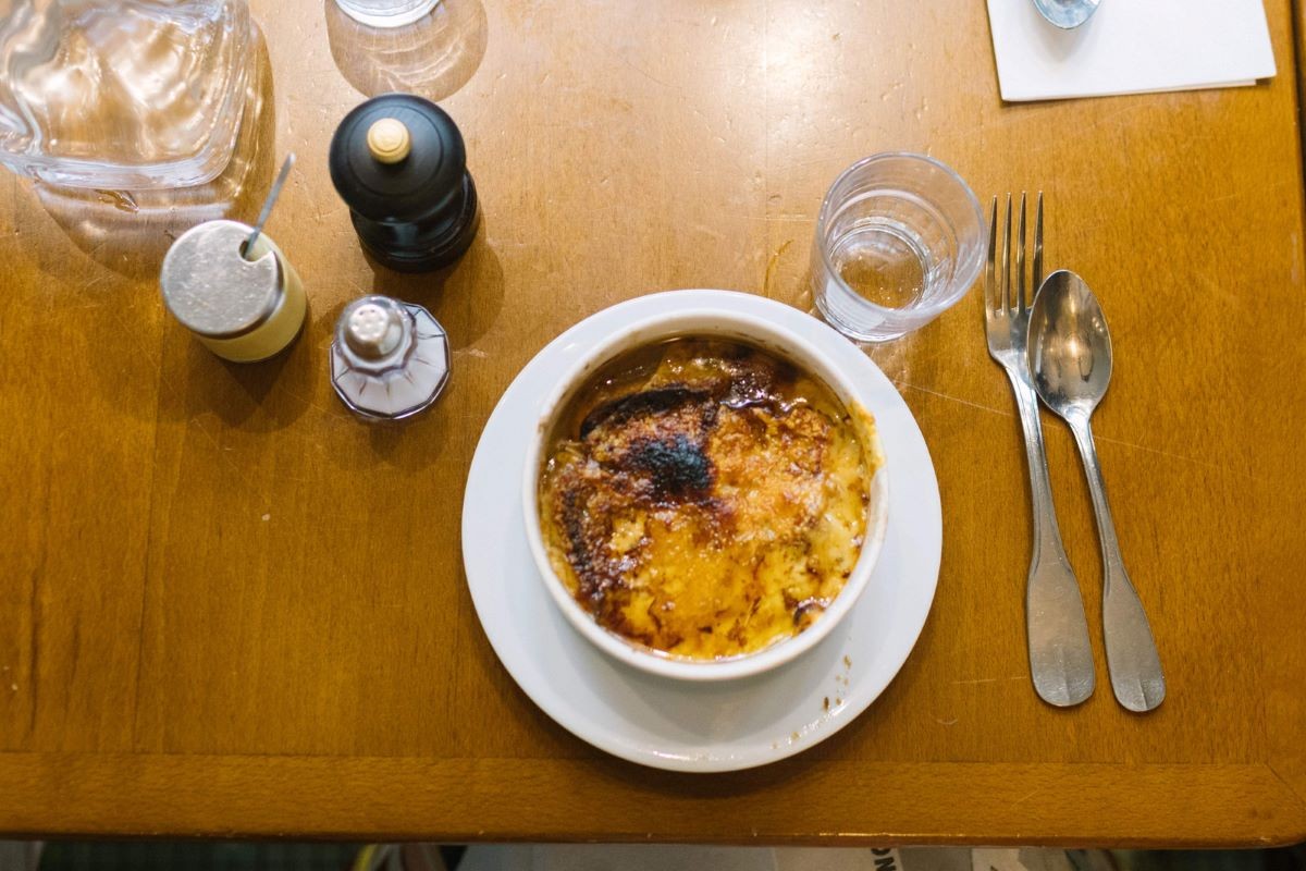 French onion soup in a bowl on a restaurant table