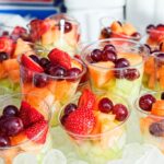 Fruits served on ice at an outdoor event, demonstrating a refreshing and visually appealing way to keep food chilled, enhancing the overall party experience.