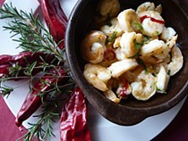 Gambas al Pil Pil in a clay dish