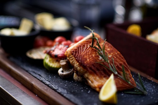 Baked salmon with lemon and herbs on a plate
