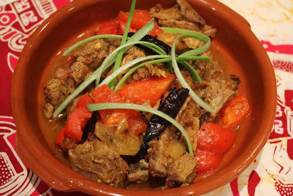 A serving of Gorkhali lamb showcasing assorted flavors, all stuffed into one package