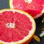 A vibrant display of fresh grapefruit halves, showcasing their juicy pulp and inviting aroma